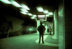 a man standing in the middle of a hallway with green light coming from his head