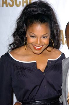 a man and woman standing next to each other on a red carpet at an event