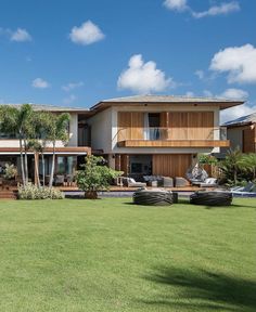 a large house sitting on top of a lush green field next to a swimming pool