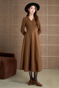 Step into timeless elegance with this vintage-inspired brown dress. Crafted from a smooth, woolen fabric, this mid-length dress features a flattering V-neckline and long sleeves. The flared skirt adds a touch of femininity and movement, making it ideal for both casual outings and special occasions. DETAIL * 30% wool, 30% fiber, 40% polyester * fully satiny lining, more nice to the touch body * Long sleeves dress * Fit and flare dress * Right zipper closure * Two side seam pockets * Belted dress * Mid-calf length dress * Vintage wool dress * Perfect for autumn, winter * Lean More about the items From the FAQs on the page bottom MODEL SIZE Bust 85 cm(33.4") Waist 67 cm(26.7") Height 168cm (5' 6") She wears size XS Choose CUSTOM Order if you * Need a better fit * Can't find your size in our s Winter Wool Dress, Calf Length Dress, Mid Dresses, Brown Dress, Mid Length Dresses, Wool Dress, Winter Dresses, Belted Dress, Fit And Flare Dress