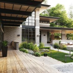 an outdoor patio with wooden decking and landscaping