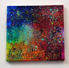 an abstract painting with multicolored paint splattered on it