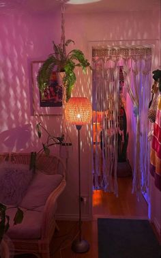 a living room filled with furniture and a purple light coming through the window to see what's inside