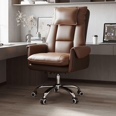 a brown leather office chair sitting on top of a hard wood floor