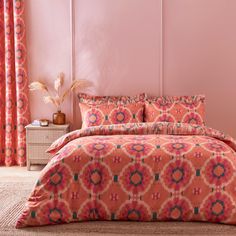 an orange and pink bed in a bedroom