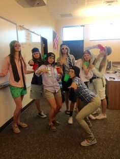 a group of young women standing next to each other in front of a whiteboard