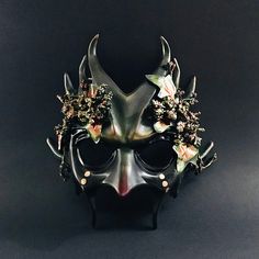 Venture into the mystical realms with our Forest Green Goblin Mask, featuring menacing horns and intricately twined foliage. Perfect for those who wish to portray a mythical woodland creature at fantasy events, Halloween, or enchanted gatherings. Age Group/Gender - Adult/Mens Size/Type - One size fits all adults Mask Color - Forest green/gold accents Mask Material - Polyresin Accent Material - Paint Special Features - Foliage Green Goblin Mask, Goblin Mask, Mask Masquerade, Green Goblin, Mythical Creature, Mask Shop, Masquerade Mask, Woodland Creatures, Green Gold