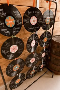 an assortment of vinyl records hanging on a wall