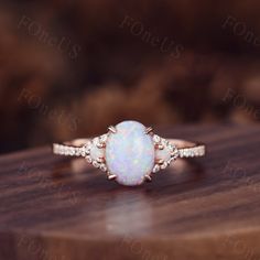 Vintage Oval white Opal Engagement Ring moissanite side stone in rose gold. Moissanite Bridal Wedding Ring,Art Deco,Unique Setting, Wedding Band In solid 14k or 18k rose/white/yellow gold,Promise ring,Christmas Gift,Anniversary gift for her. Details --Engagement Ring-- Stone: Moissanite Weight: 1.5 Carat Stone Size: 6x8mm Shape: Oval cut Side stones: Opal + Moissanite ◇◇Processing time◇◇ Any item on my store is handmade,made to order,no stock. Typically,it takes 3-4 weeks to complete the item. ◇◇Delivery time◇◇ --Domestic-- Standard shipping:5-7 working days for arrival Express shipping:2-4 business days for arrival --Overseas-- Standard shipping:1-2/3-4 weeks for arrival Express shipping:3-5 business days for arrival ❤I'll do my best to meet these shipping estimates, but cannot guarantee Boho Vintage Engagement Ring, Gold Three Stone Engagement Ring, Oval Opal Ring, White Opal Engagement Ring, Opal Promise Ring, Rose Gold Opal Ring, Engagement Ring Moissanite, Engagement Ring Oval, Opal Engagement Ring