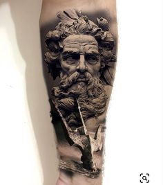 a man's arm with a tattoo on it that has an image of a bearded man