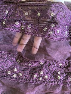 This is a semi-sheer, soft, and fluffy plum organza fabric.  It has plum (tone to tone) embroidered floral motifs all over the fabric in parallel rows. Each parallel row of embroidered motifs is about 3 inches wide. The intricate embroidery has been done in soft silk threads. The embroidery has been further embellished with muted gold sequins. The sequins are sewn in the shape of small flowers. Sequins are sewn (not pasted), so will not fall off with use. All four edges are hemmed with silk thre Embroidered Motifs, Organza Fabric, Intricate Embroidery, Fabric Remnants, Gold Sequins, Semi Transparent, Silk Thread, Bridal Veil, Floral Motifs