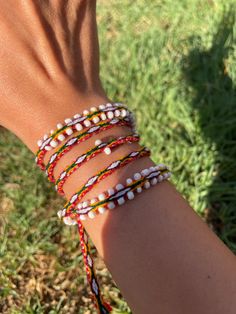 a woman's arm with several bracelets on it