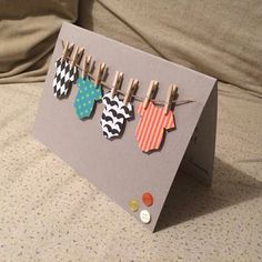 a card with clothes pins attached to it