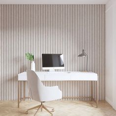 a white desk with a computer on it in front of a wallpapered room