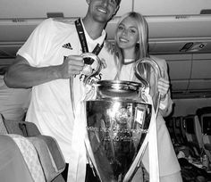 a man and woman posing with a trophy