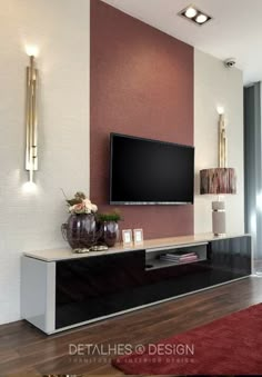 a large flat screen tv mounted to the side of a wall in a living room