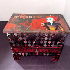 an old chest with a doll painted on it