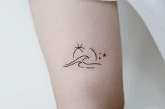 a woman's arm with a small wave and star tattoo on the left side