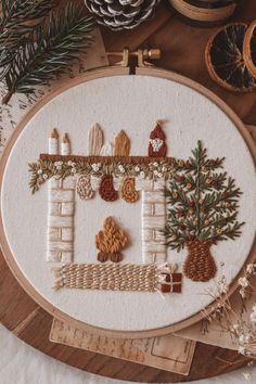 a cross stitch pattern with pine cones and trees