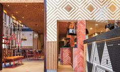 the inside of a restaurant with tables, chairs and walls painted in geometric patterns on them