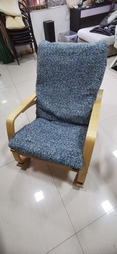 a blue chair sitting on top of a white tile floor