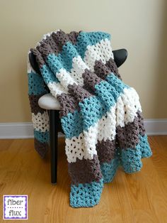 a crocheted blanket sitting on top of a chair