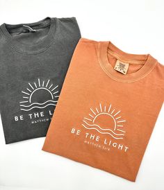 Embroidered Be The Light Matthew 5:14 Comfort Colors® Shirt | Inspirational Christian Tee | Religious Faith Clothing | Bible Verse Gifts The item in the first picture features Cream thread color on a Pepper Comfort Colors T-shirt. The item in the first picture features Sand thread color on a Bay Comfort Colors T-shirt. The item in the first picture features Doe Skin Beige thread color on an Ivory Comfort Colors T-shirt. The item in the first picture features Cream thread color on a Yam Comfort C Christian Boutique, Be The Light Shirt, Christian Gift Shop, Pray Shirt, Christian Camp, Christian Tshirt Design, Bible Verse Gifts, Matthew 5