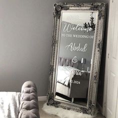 a large mirror sitting next to a couch in a living room on top of a carpeted floor