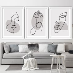 three black and white art prints on the wall above a couch in a living room