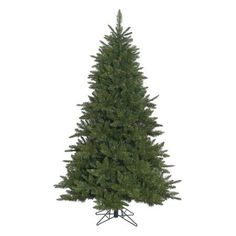 a small christmas tree on a stand against a white background