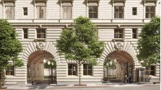 an artist's rendering of the entrance to a building with arched doorways and trees