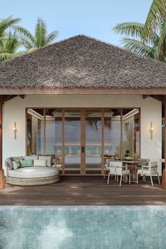 an outdoor living area next to a swimming pool