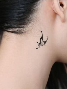 a woman with a small tattoo on her neck