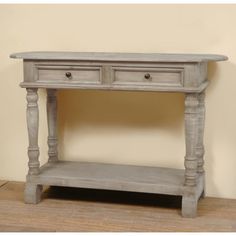 an old gray table with two drawers on one side and a shelf underneath it for storage