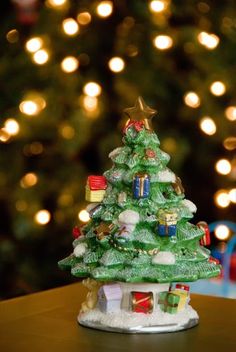 a small green christmas tree sitting on top of a table