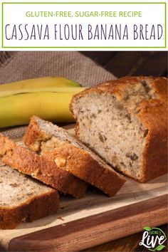 sliced banana bread sitting on top of a wooden cutting board next to a ripe banana