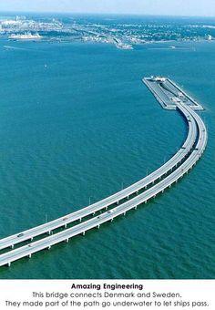 an aerial view of a bridge spanning the ocean