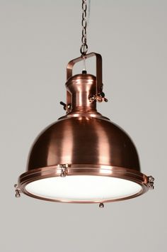 an antique style pendant light hanging from a chain