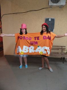 two girls holding up an orange shirt that says do not be dab u n abracs