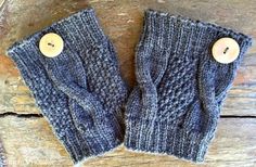 two blue knitted mittens with buttons on them