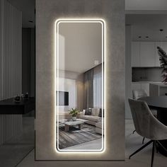 a living room with a large mirror on the wall next to a table and chairs