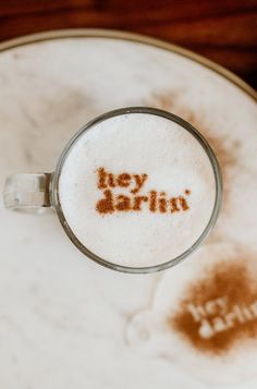 a close up of a cup of coffee with the word joy barin written on it