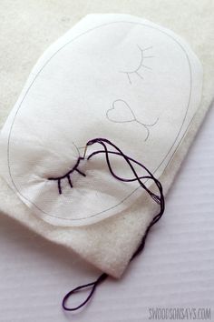 a piece of cloth with some thread on it