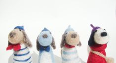 three stuffed dogs wearing sweaters and scarves are lined up in the same row