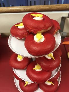 a stack of red donuts with yellow lightning decorations