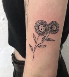 a woman's arm with two flowers on it