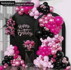 a birthday party with balloons and flowers on the front door, decorated in pink and black