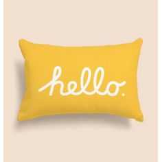 a yellow pillow with the word hello written on it in white ink, against a beige background