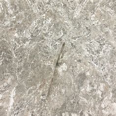 the floor is made up of marble and has a gray pattern on it, as well as an arrow