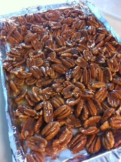 there are many pecans on top of the tin foil covered baking sheet that is ready to be baked